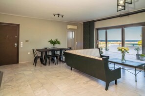 Lily's Penthouse-Living room area with corner sofa , dining table for 6 people