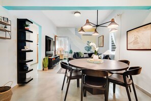 An open-plan living and dining space featuring chic decor and a cozy atmosphere.