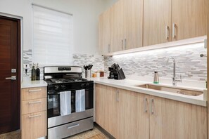 A fully equipped kitchen with sleek, modern design, perfect for preparing your favorite meals.
