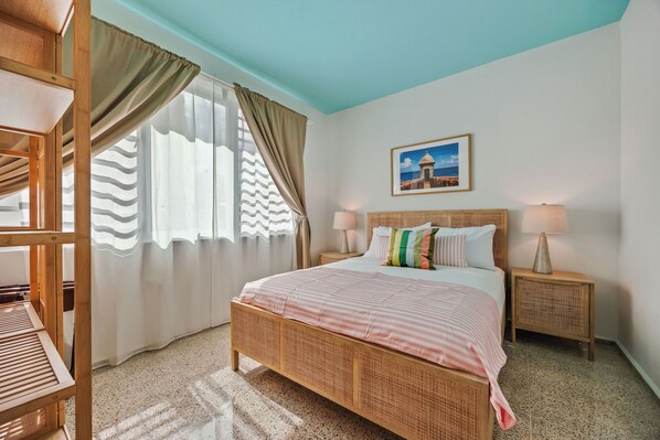 Recharge in this peaceful, modern bedroom with a cozy bed, warm lighting, and soothing neutral colors.