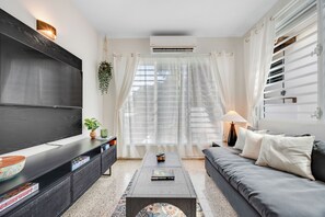 Unwind in this bright, minimalist living area with modern furniture and a serene, open feel.
