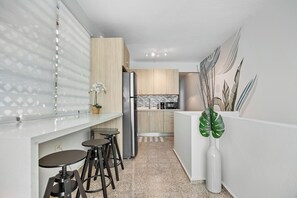 Enjoy a home-cooked meal or morning coffee in this stylish kitchen with a cozy dining nook.