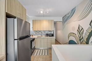 Whip up your favorite dishes in this well-equipped, clean kitchen with a minimalist and inviting vibe.