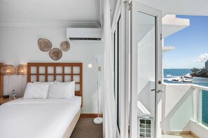A serene bedroom that opens directly to a balcony, where the beach becomes your personal paradise.