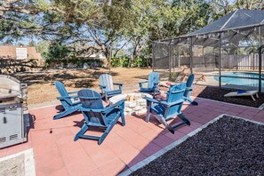 Relax by the fire pit in the paved seating area, fire up the grill for your favorite dishes, or test your skills in a friendly game of cornhole. The spacious backyard, lit by charming string lights, sets the ideal scene for unwinding or hosting gatherings. Plus, complimentary firewood and fire starters are included!