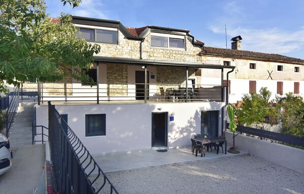 The front side of the house and the windows of the apartment on the 2nd floor