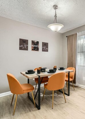 A comfy and well-lit dining area that seats 4.