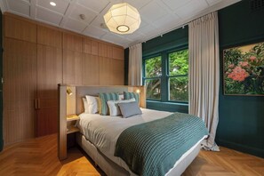 Get a good night’s sleep in the bedroom. It highlights a queen-sized bed with integrated lighting.