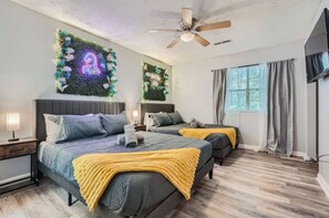 Bedroom 1: Two cozy queen beds and a smart TV for ultimate comfort.



