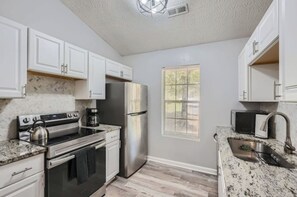 A kitchen with all essential appliances and tools.