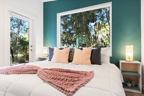Experience ultimate comfort in this spacious king bed.  Nestled at the back of the property and surrounded by a stunning backdrop of lush trees—your peaceful retreat awaits!