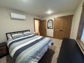 Bedroom with queen bed and smart TV