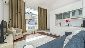 Open-concept living area with a fully equipped kitchen and contemporary decor. The perfect space to relax and recharge. #Kitchenette