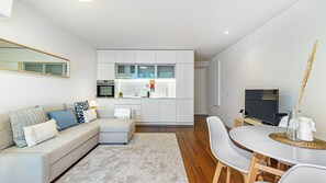 Chic open-concept living space with a fully equipped kitchen and cozy lounge area. Modern design, natural light, and premium comfort await! #LivingArea #Airbnb