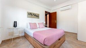 Unwind in this bright and airy bedroom with soft pink accents and a peaceful ambiance. #ComfortAndStyle #RelaxAndRecharge