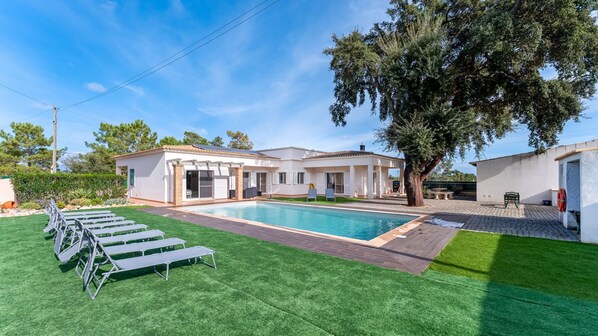 Relax by the sparkling pool surrounded by lush greenery and ample lounging space. The perfect retreat for sunny days! #PrivatePool #OutdoorEscape