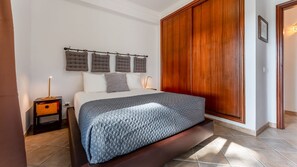 Wake up to pool views in this sophisticated bedroom featuring sleek decor and a private patio. #PoolsideLuxury #ModernLiving