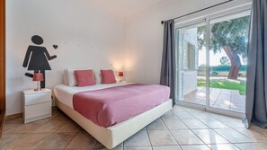 A playful and bright bedroom with unique wall art, ideal for kids or anyone young at heart. #FunAndCozy #ArtfulStay