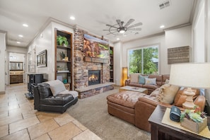 Cozy and spacious living area with smart TV and fireplace