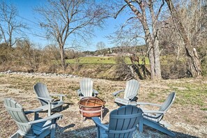 Unwind around the fire pit in our peaceful outdoor seating area, with scenic countryside views and even a friendly horse nearby!