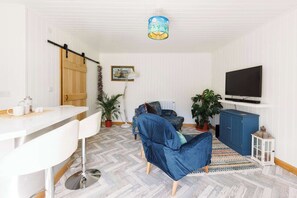 You will find a comfortable living area with smart TV, and well-equipped kitchen featuring a breakfast bar for casual dining.