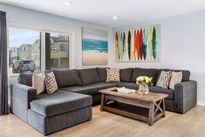 The living room features a large sectional sofa.