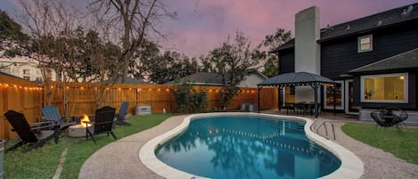 Welcome to a backyard oasis! Beautifully landscaped for a resort-like feel, take a dip in the pool, settle in around the cozy fire pit, or enjoy an al fresco dinner on the patio.