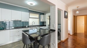 Fully equipped modern kitchen with sleek appliances and ample counter space, perfect for preparing meals during your stay. A functional and stylish space for your culinary needs. #diningtable