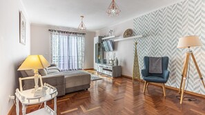 Stylish living room featuring modern decor with elegant touches, a cozy rug, vibrant cushions, and tasteful artwork, creating a warm and inviting ambiance for relaxation. #decordetails