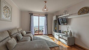 Unwind on the comfortable sofa after a day of hiking Madeira’s trails, soaking in the serene ocean view from the living room’s tranquil setting. #livingroom #oceanview