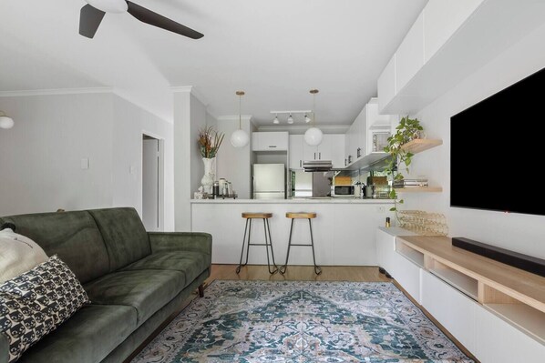 Open plan living is bright and airy, with ample space for all guests to come together for shared meals or movie nights at home.