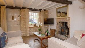 Wooden beams and exposed stone show the history of the cottage