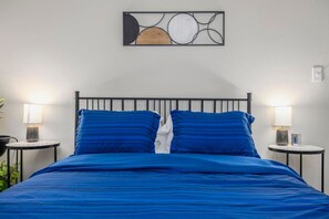 Each bedroom has a queen bed, night stands, lamps, a closet, and clothing storage.