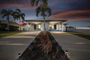 Charming view of the property illuminated with stunning lights creating a warm, inviting atmosphere that truly shines at night.