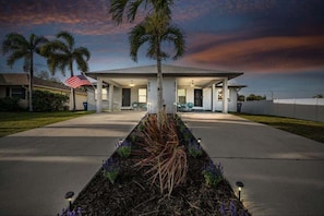 Charming view of the property illuminated with stunning lights creating a warm, inviting atmosphere that truly shines at night.