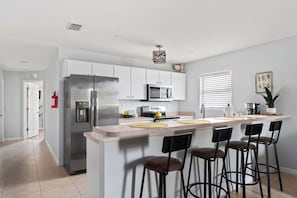 Bright and fully equipped kitchen with modern appliances, ample counter space, and everything you need to cook a meal or enjoy a quick snack. Perfect for morning coffee or family dinners.