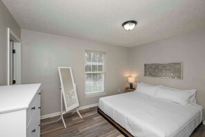 The first bedroom retreat boasts a plush king bed & ensuite bath