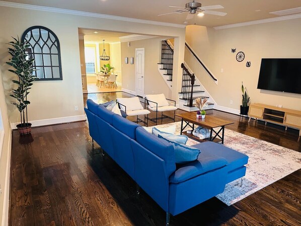 Spacious and cozy living room with smart TV and comfortable seating area