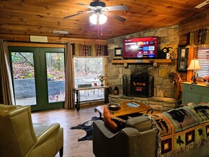 The living room has a TV/DVD player and cozy fireplace, couch & recliner