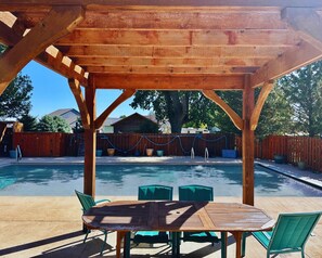Enjoy a meal at the dining table, or take a refreshing dip in the pool.