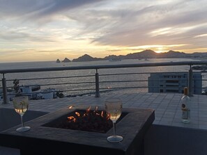 Enjoying a glass of wine with firepit lite at Sunset.