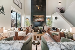Mountain modern living room with a gas fireplace, 65 inch tv, beautiful artwork!