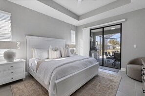 Primary bedroom with attached bathroom, lanai access, king bed and 43" Smart TV