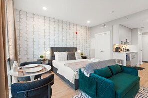 Our studio unit features a stylish, thoughtfully designed bedroom with a comfortable bed for restful nights, along with a sofa bed for extra guests. It also offers a dedicated workspace desk, ideal for productivity, and a TV for relaxing evenings, perfect