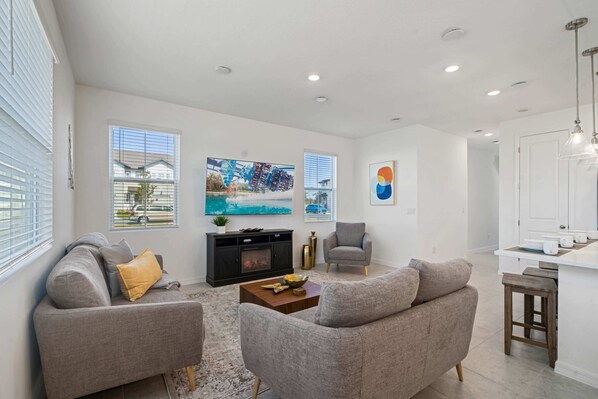 - Cozy living room featuring plush seating and a large smart TV for entertainment - Bright, open design and modern decor create a warm & inviting atmosphere - Perfect for unwinding after a day of adventures or spending quality time with loved ones