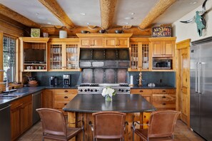 Kichen with large island with additional seating for 3 guests