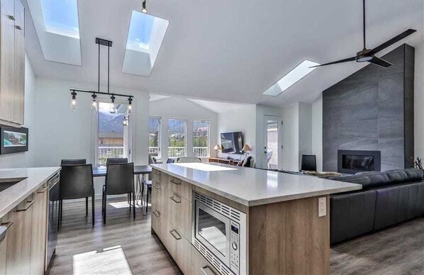 An open layout of Living/Kitchen/Dining/ Sitting area with panorama mountain views.

Central AC & Skylights. 