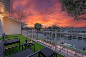 Relax on the master suite's upper-level balcony, basking in the sunshine