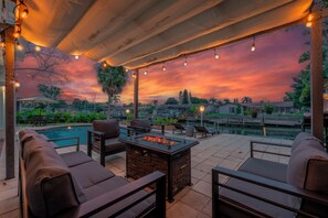 Indulge in breathtaking water views in the fresh air by the patio fire table