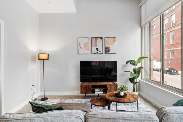 You feel at home as you settle into the living room, where the inviting atmosphere is perfect for lounging or entertaining.